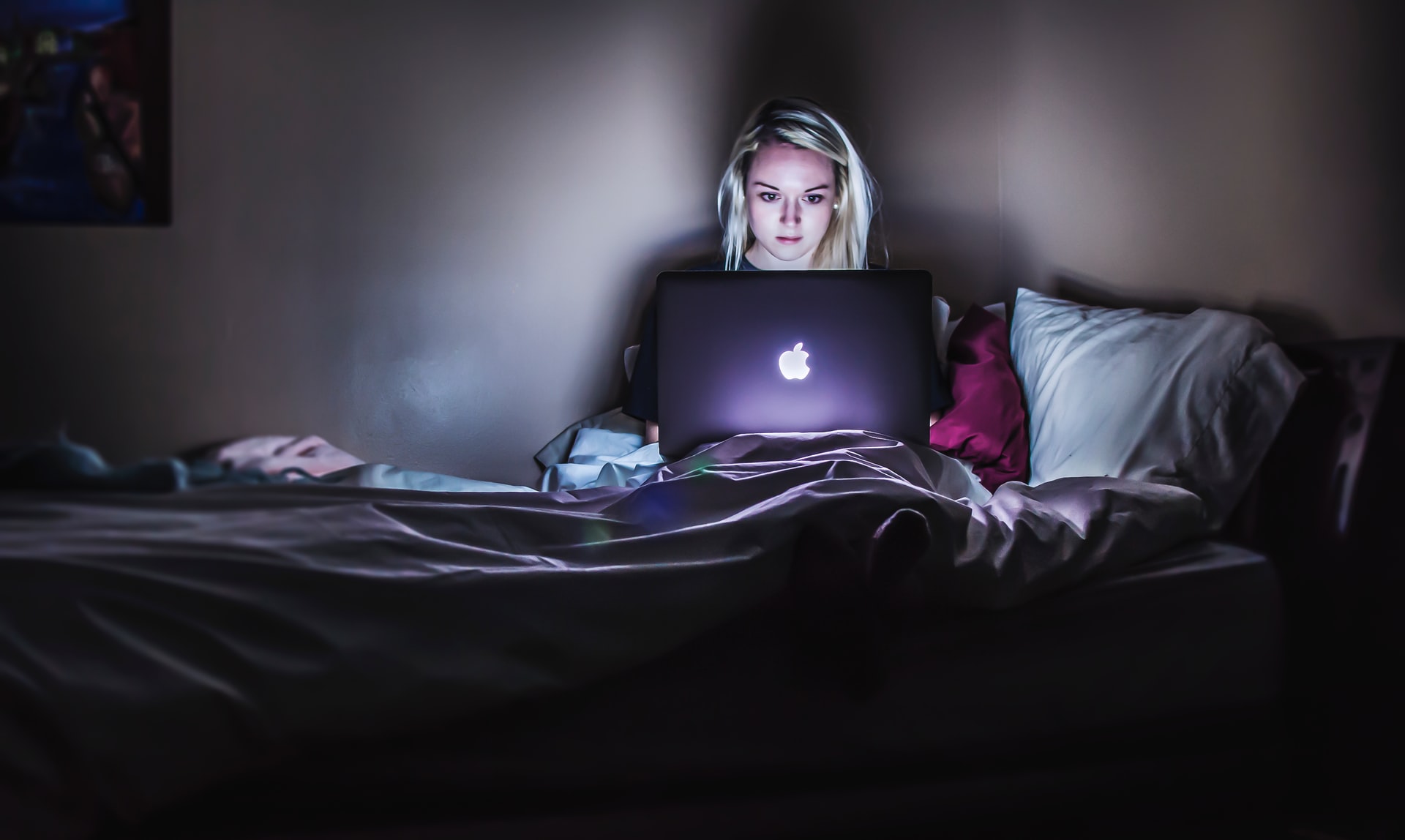 Woman using laptop late at night